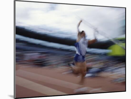 Pole Vaulter Flys over the Bar-Steven Sutton-Mounted Photographic Print