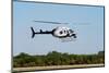 Police Helicopter Flying above a Tree Line on a Sunny Day-icholakov-Mounted Photographic Print