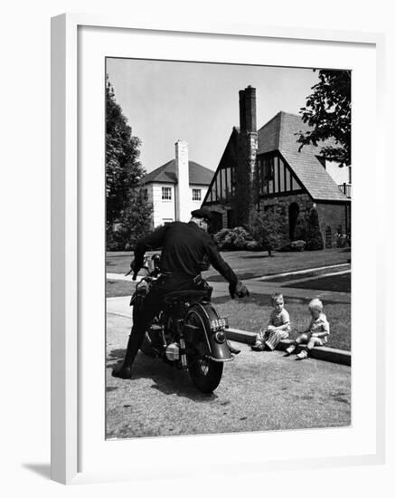 Policeman on Motorcycle Chatting with Toddler Boys Sitting on Curb-Alfred Eisenstaedt-Framed Photographic Print