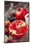 Pomegranate and Bottles of Essence or Tincture on Table-ChamilleWhite-Mounted Photographic Print