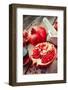 Pomegranate, Juice in Glass, Mortar and Pestle on Wooden Table-ChamilleWhite-Framed Photographic Print