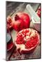 Pomegranate, Juice in Glass, Mortar and Pestle on Wooden Table-ChamilleWhite-Mounted Photographic Print