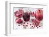 Pomegranates and Glass with Pomegranate Juice on White Wooden Table-Jana Ihle-Framed Photographic Print