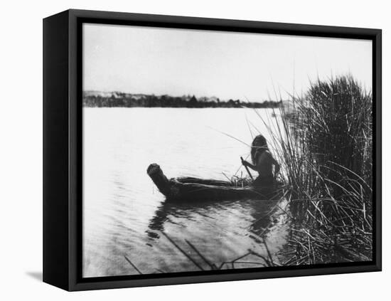 Pomo Indian Poling His Boat Made of Tule Rushes Through Shallows of Clear Lake, Northen California-Edward S^ Curtis-Framed Stretched Canvas