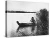 Pomo Indian Poling His Boat Made of Tule Rushes Through Shallows of Clear Lake, Northen California-Edward S^ Curtis-Stretched Canvas