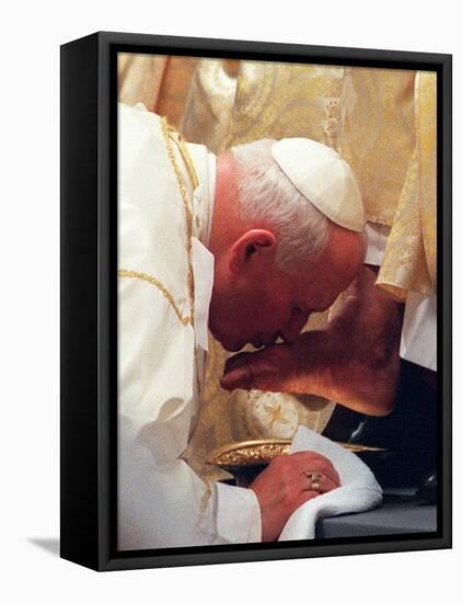 Pope John Paul II Kisses the Foot of a Clergyman-null-Framed Stretched Canvas