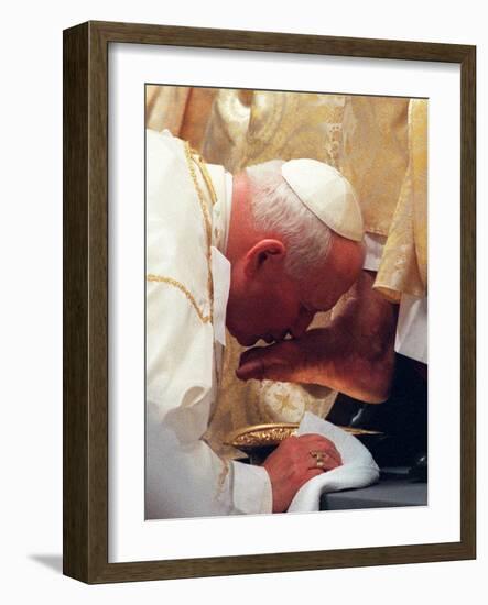 Pope John Paul II Kisses the Foot of a Clergyman-null-Framed Photographic Print