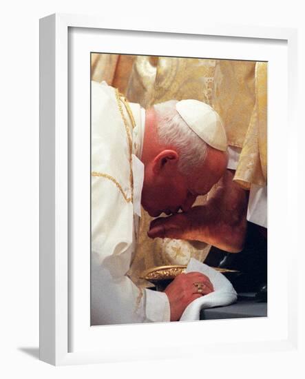 Pope John Paul II Kisses the Foot of a Clergyman-null-Framed Photographic Print