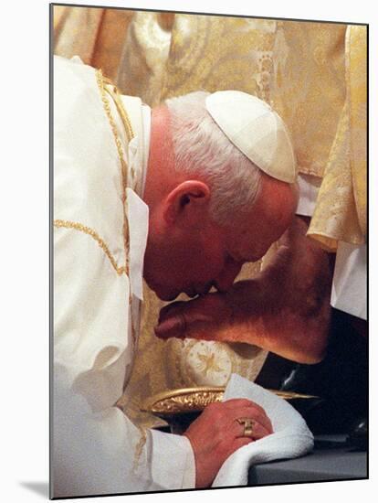 Pope John Paul II Kisses the Foot of a Clergyman-null-Mounted Photographic Print