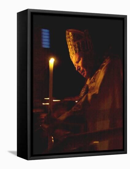 Pope John Paul II Prays Before a Candle at the Beginning of an Holy Easter Vigil Mass-null-Framed Stretched Canvas