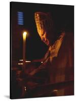 Pope John Paul II Prays Before a Candle at the Beginning of an Holy Easter Vigil Mass-null-Stretched Canvas