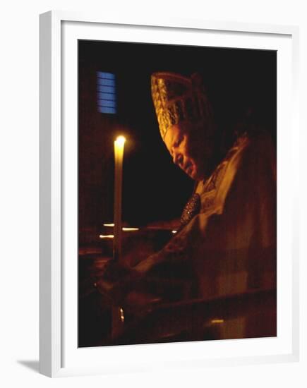 Pope John Paul II Prays Before a Candle at the Beginning of an Holy Easter Vigil Mass-null-Framed Premium Photographic Print