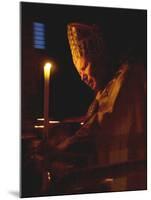 Pope John Paul II Prays Before a Candle at the Beginning of an Holy Easter Vigil Mass-null-Mounted Premium Photographic Print