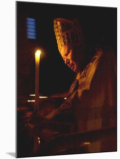 Pope John Paul II Prays Before a Candle at the Beginning of an Holy Easter Vigil Mass-null-Mounted Premium Photographic Print