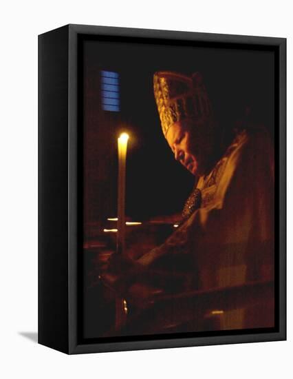 Pope John Paul II Prays Before a Candle at the Beginning of an Holy Easter Vigil Mass-null-Framed Stretched Canvas