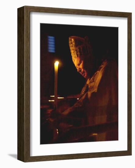 Pope John Paul II Prays Before a Candle at the Beginning of an Holy Easter Vigil Mass-null-Framed Photographic Print