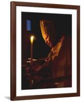 Pope John Paul II Prays Before a Candle at the Beginning of an Holy Easter Vigil Mass-null-Framed Photographic Print