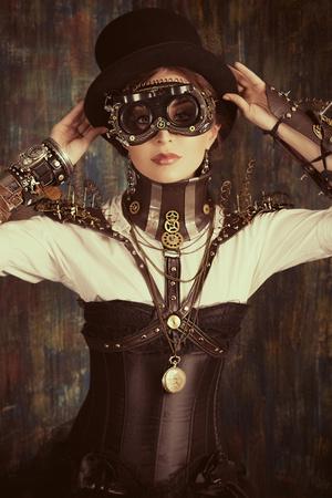 https://imgc.allpostersimages.com/img/posters/portrait-of-a-beautiful-steampunk-woman-over-grunge-background_u-L-PN0A8Y0.jpg?artPerspective=n