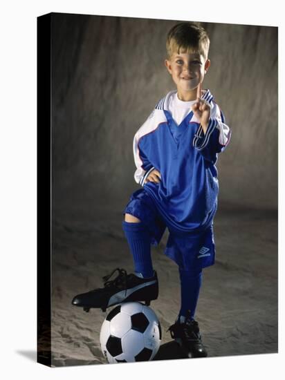 Portrait of a Boy Standing with His Foot on a Soccer Ball-null-Stretched Canvas