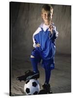 Portrait of a Boy Standing with His Foot on a Soccer Ball-null-Stretched Canvas