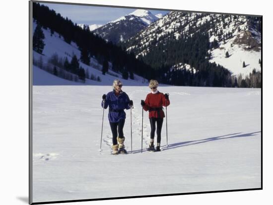 Portrait of a Senior Woman and a Young Woman Standing Wearing Skis-null-Mounted Photographic Print