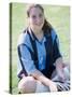 Portrait of a Teenage Girl Sitting on a Lawn Smiling-null-Stretched Canvas