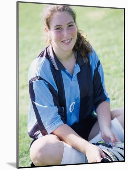 Portrait of a Teenage Girl Sitting on a Lawn Smiling-null-Mounted Photographic Print