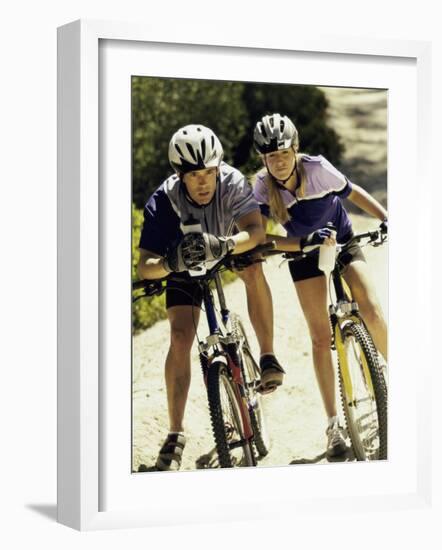 Portrait of a Young Couple Sitting on Bicycles-null-Framed Photographic Print