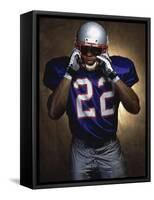 Portrait of an American Football Player Removing His Helmet-null-Framed Stretched Canvas