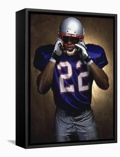 Portrait of an American Football Player Removing His Helmet-null-Framed Stretched Canvas