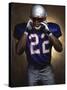 Portrait of an American Football Player Removing His Helmet-null-Stretched Canvas