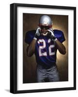 Portrait of an American Football Player Removing His Helmet-null-Framed Premium Photographic Print