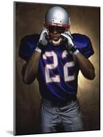 Portrait of an American Football Player Removing His Helmet-null-Mounted Photographic Print