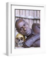 Portrait of an Asmat Tribesman Leaning on a Human Skull, Irian Jaya, Indonesia-Claire Leimbach-Framed Photographic Print