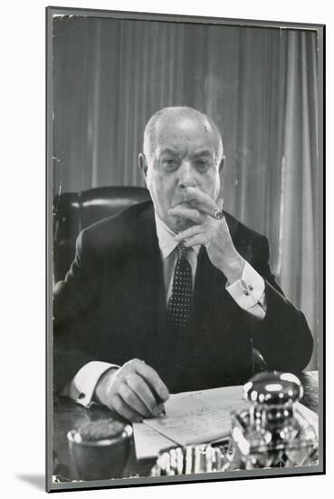 Portrait of RCA Chairman David Sarnoff Sitting at Desk in His Office, Smoking a Cigar-Alfred Eisenstaedt-Mounted Photographic Print