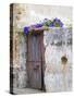 Portugal, Aveiro. Old red metal door with bright blue and pink morning glory flower-Julie Eggers-Stretched Canvas