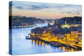 Portugal, Douro Litoral, Porto. Dusk in the UNESCO listed Ribeira district, viewed from Dom Luis I -Nick Ledger-Stretched Canvas