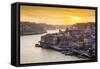 Portugal, Douro Litoral, Porto. Sunset over the UNESCO listed Ribeira district, viewed from Dom Lui-Nick Ledger-Framed Stretched Canvas