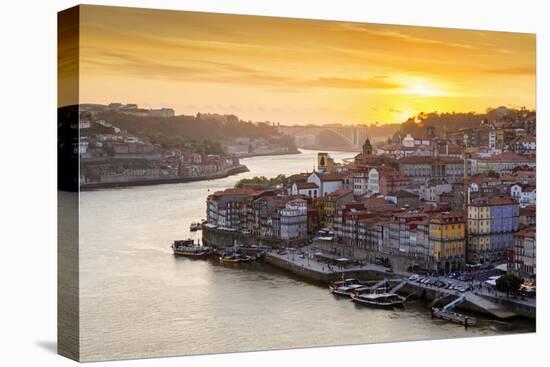 Portugal, Douro Litoral, Porto. Sunset over the UNESCO listed Ribeira district, viewed from Dom Lui-Nick Ledger-Stretched Canvas