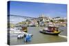 Portugal, Douro Litoral, Porto. Tourists boats on Douro River in the UNESCO listed Ribeira district-Nick Ledger-Stretched Canvas