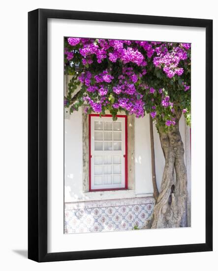 Portugal, Lisbon. Pink flowers of Bougainvillea plant and historical building-Julie Eggers-Framed Photographic Print