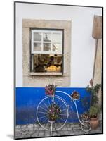 Portugal, Obidos. Cute bicycle planter in front of a bakery in the walled city of Obidos.-Julie Eggers-Mounted Photographic Print