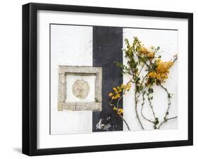 Portugal, Obidos. Orange bougainvillea growing against a wall and carved sculpture on wall.-Julie Eggers-Framed Photographic Print