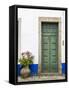 Portugal, Obidos. Pink hydrangea in terracotta pot next to a green door.-Julie Eggers-Framed Stretched Canvas