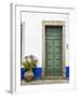 Portugal, Obidos. Pink hydrangea in terracotta pot next to a green door.-Julie Eggers-Framed Photographic Print