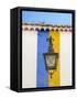 Portugal, Obidos. Wrought iron lantern hanging from a colorful stripped wall in the walled town.-Julie Eggers-Framed Stretched Canvas