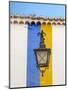 Portugal, Obidos. Wrought iron lantern hanging from a colorful stripped wall in the walled town.-Julie Eggers-Mounted Photographic Print