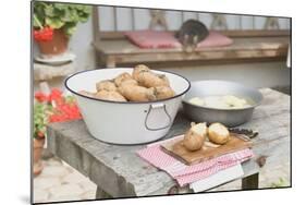 Potatoes, Partly Peeled, on Table in Front of Farmhouse-Eising Studio - Food Photo and Video-Mounted Photographic Print