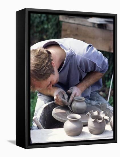 Potter at Work on Wheel at Rustic Fayre, Devon, England, United Kingdom-Ian Griffiths-Framed Stretched Canvas