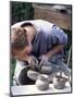 Potter at Work on Wheel at Rustic Fayre, Devon, England, United Kingdom-Ian Griffiths-Mounted Photographic Print